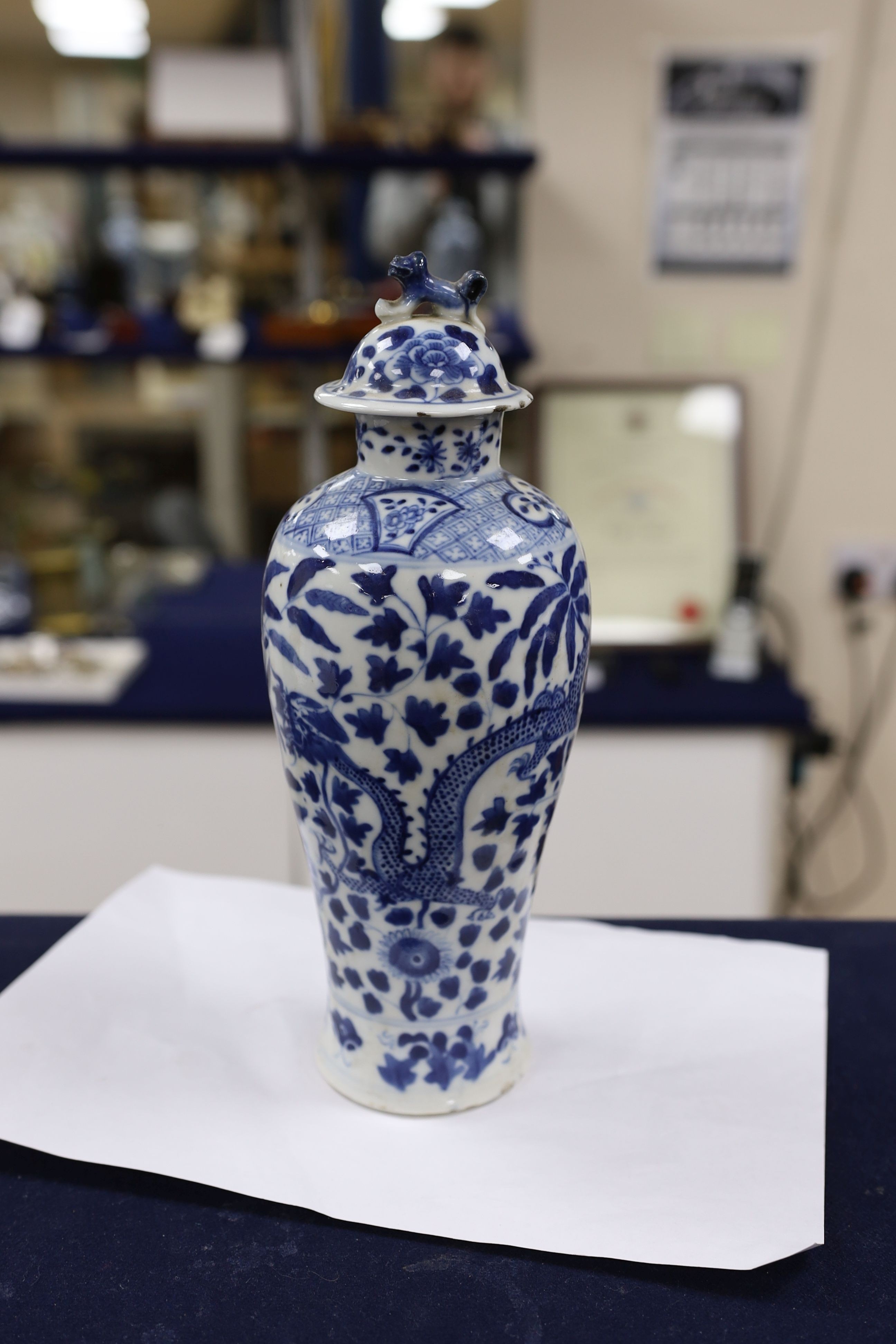 A pair of Chinese blue and white dragon vases and covers, circa 1900. 28cm